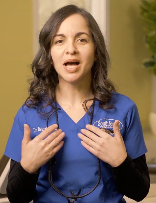 Top dentist is smiling and looking at the camera