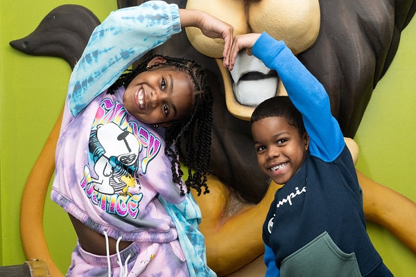 Two kids are smiling and playing