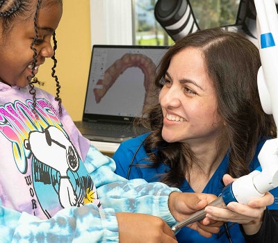 South Jersey Pediatric dentist is smiling and high-fiving a joyful kid