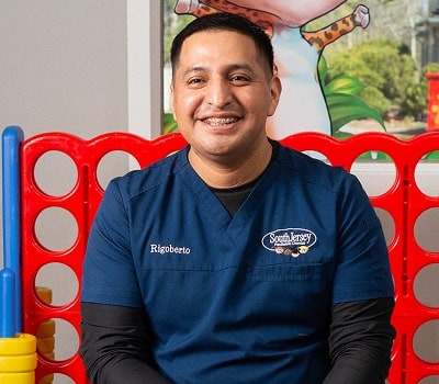 Dentist is smiling in a playroom for children at South Jersey Pediatric