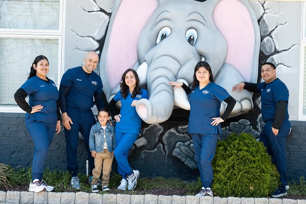 South Jersey pediatric team is smiling in front of an elephant statue